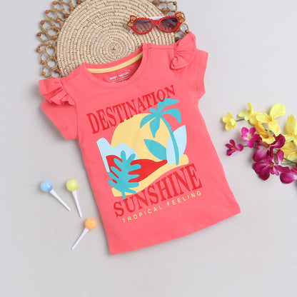 Coral pink children's t-shirt with 'Destination Sunshine' print on a light gray background