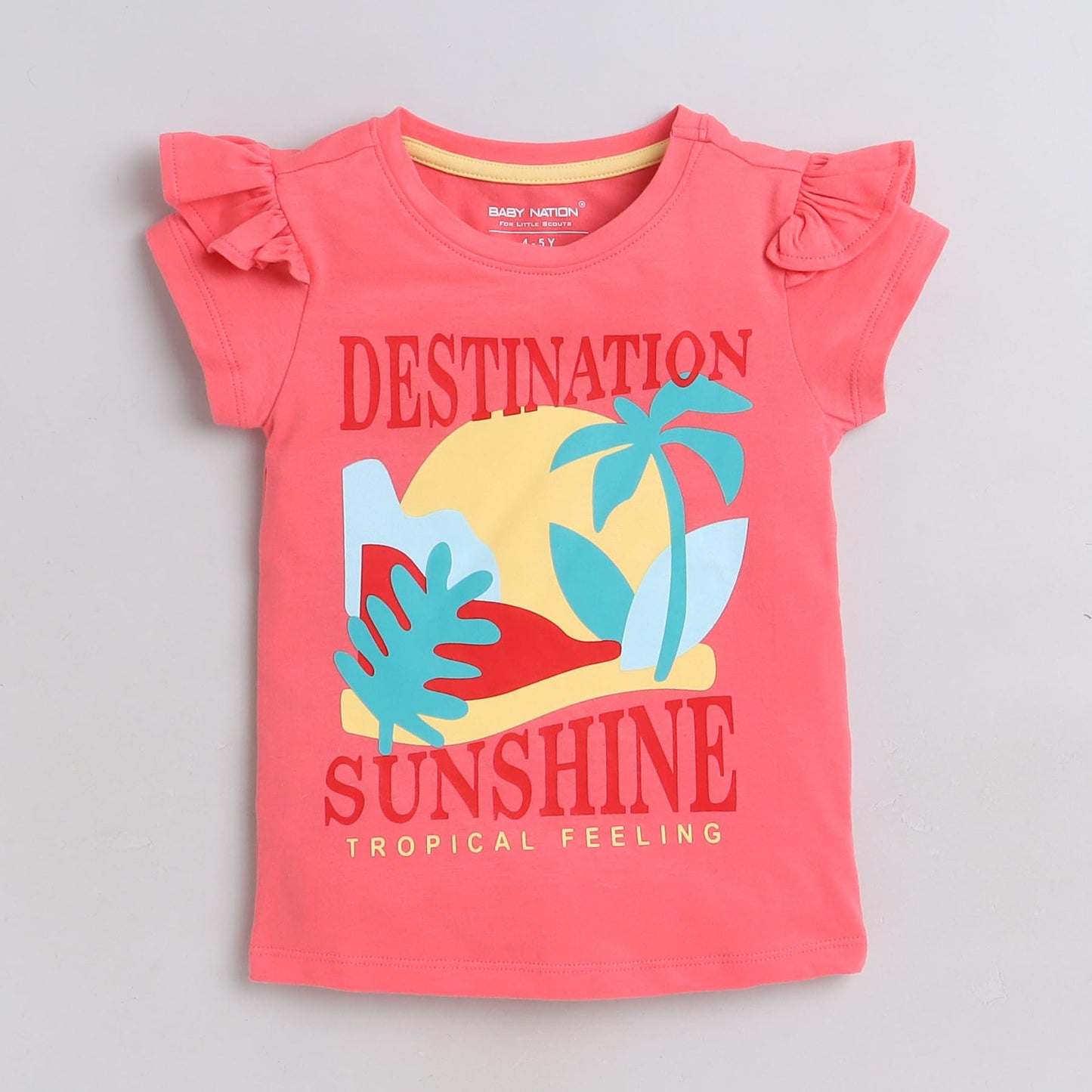 Coral pink children's t-shirt with 'Destination Sunshine' text and tropical graphics on a light gray background.