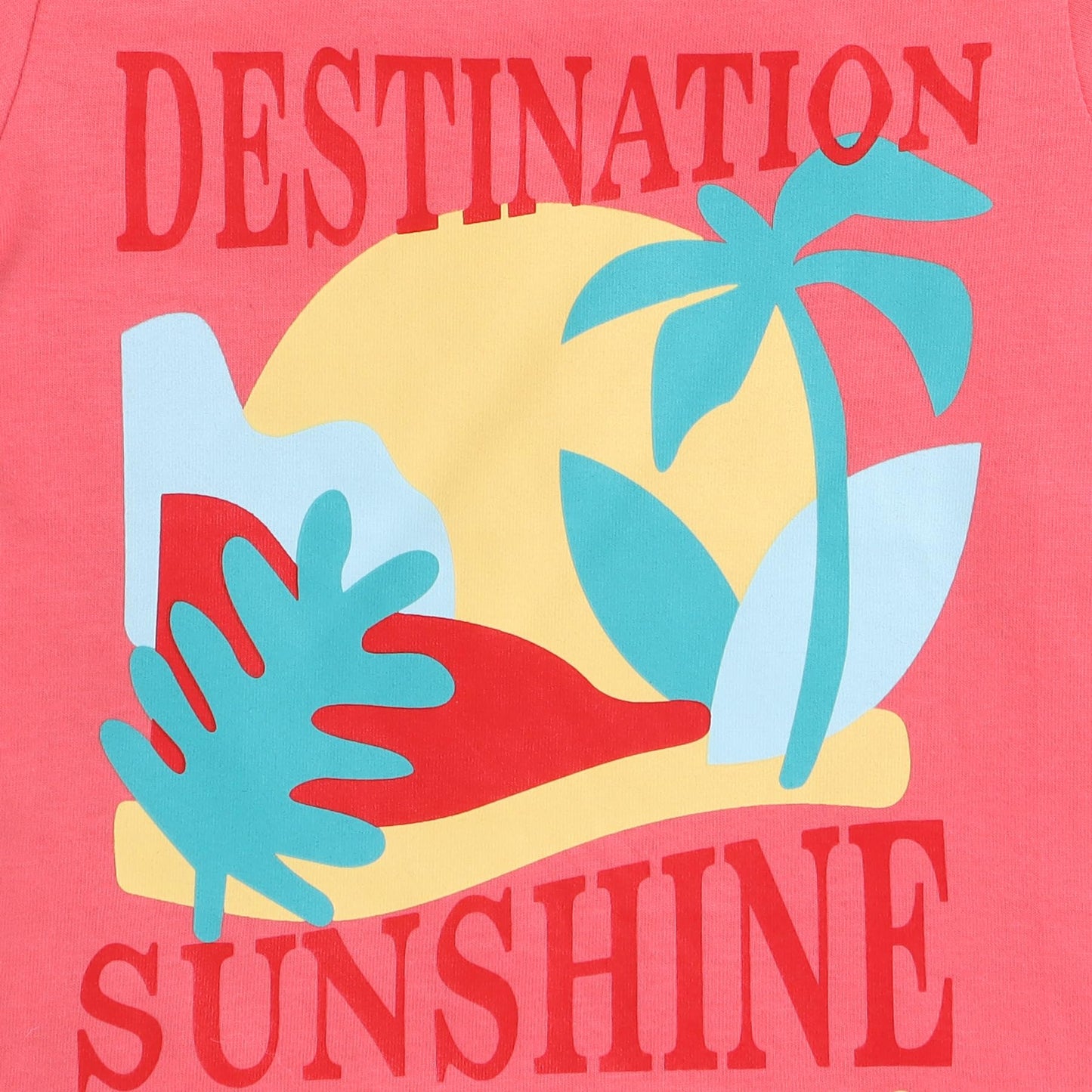 T-shirt with 'Destination Sunshine' design featuring palm trees and a sun on a pink background.