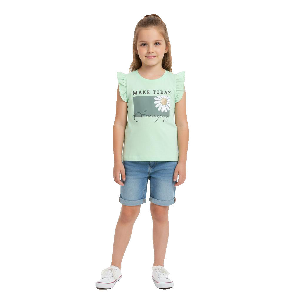 Young girl wearing a light green t-shirt with a graphic and blue shorts on a white background
