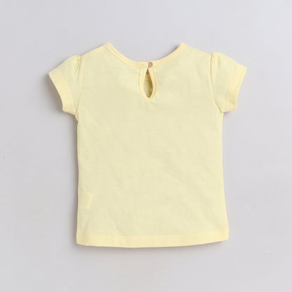 Yellow short-sleeve top on a light gray background