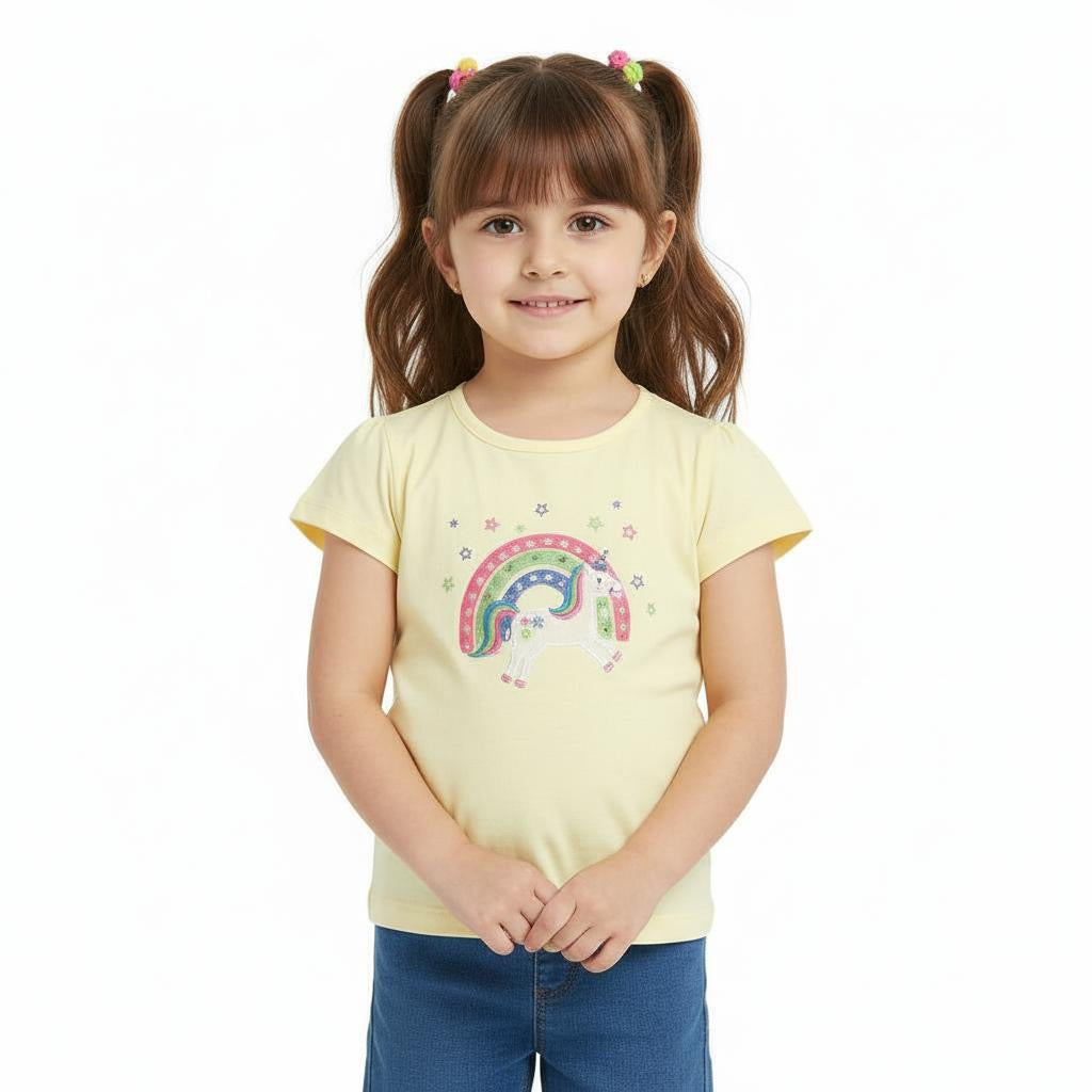 Young girl wearing a yellow t-shirt with a rainbow design on a white background