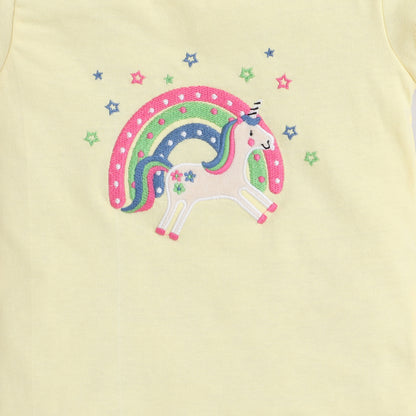 Embroidered unicorn design on a light yellow fabric background